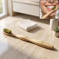 Bamboo toothbrush with soft green bristles and light wood handle, 1 piece.