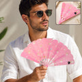 Pink foldable hand fan with floral pattern, held open in a pocket-ready size