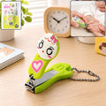 Kids nail clipper keychain in lime green with cartoon face and heart, metal cutter