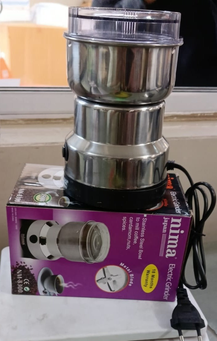 Mini electric stainless steel spice grinder with clear lid and black base