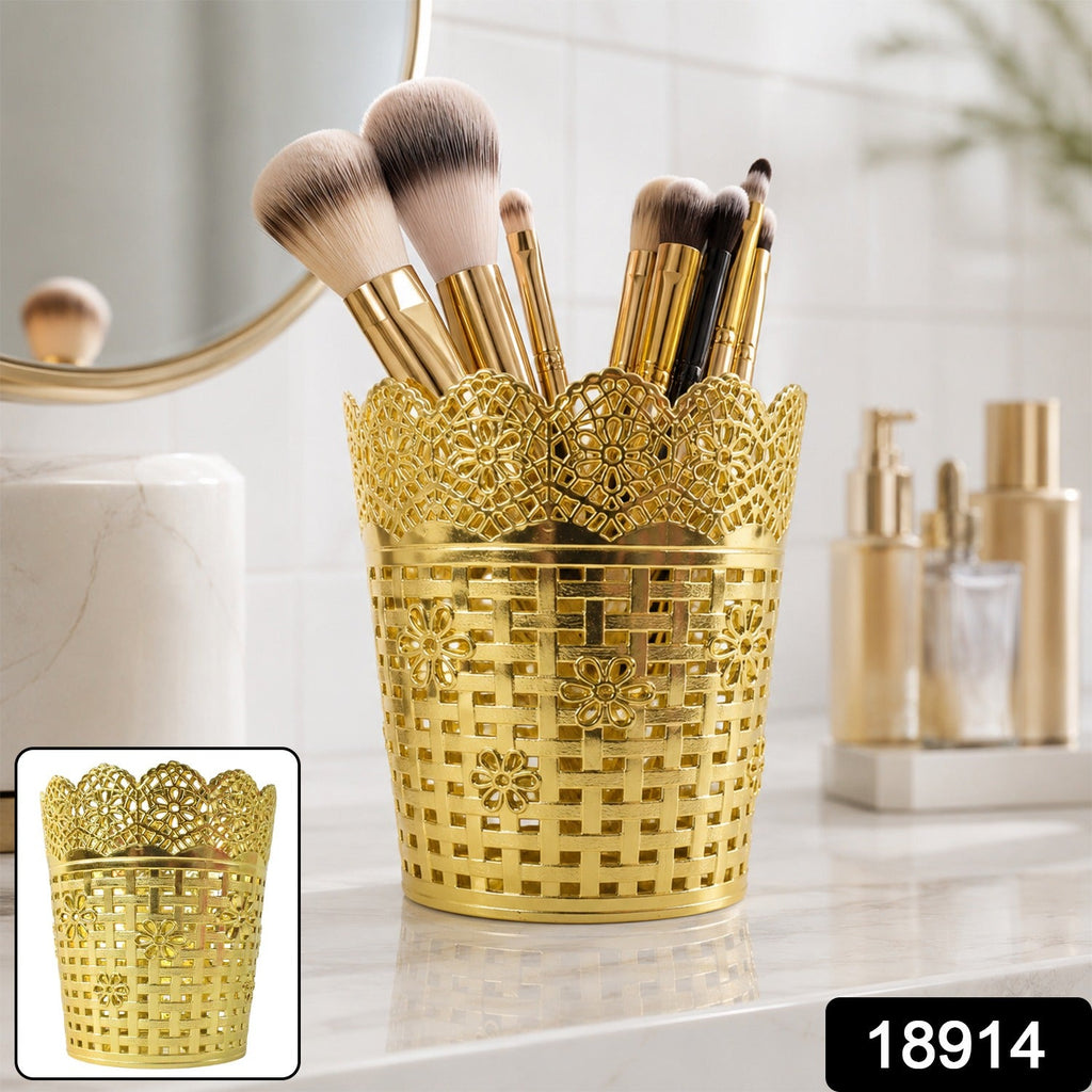 Gold metal mesh makeup brush organizer stand with ornate floral lattice pattern, open top
