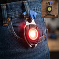 Red keychain mini flashlight with bright LED, clipped to blue denim jeans pocket