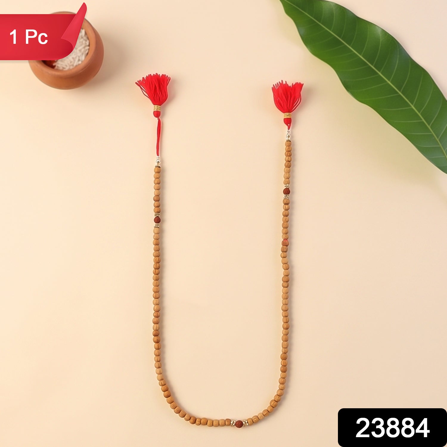 Sandalwood mala necklace with light wood beads, small red bead accents, and red tassels