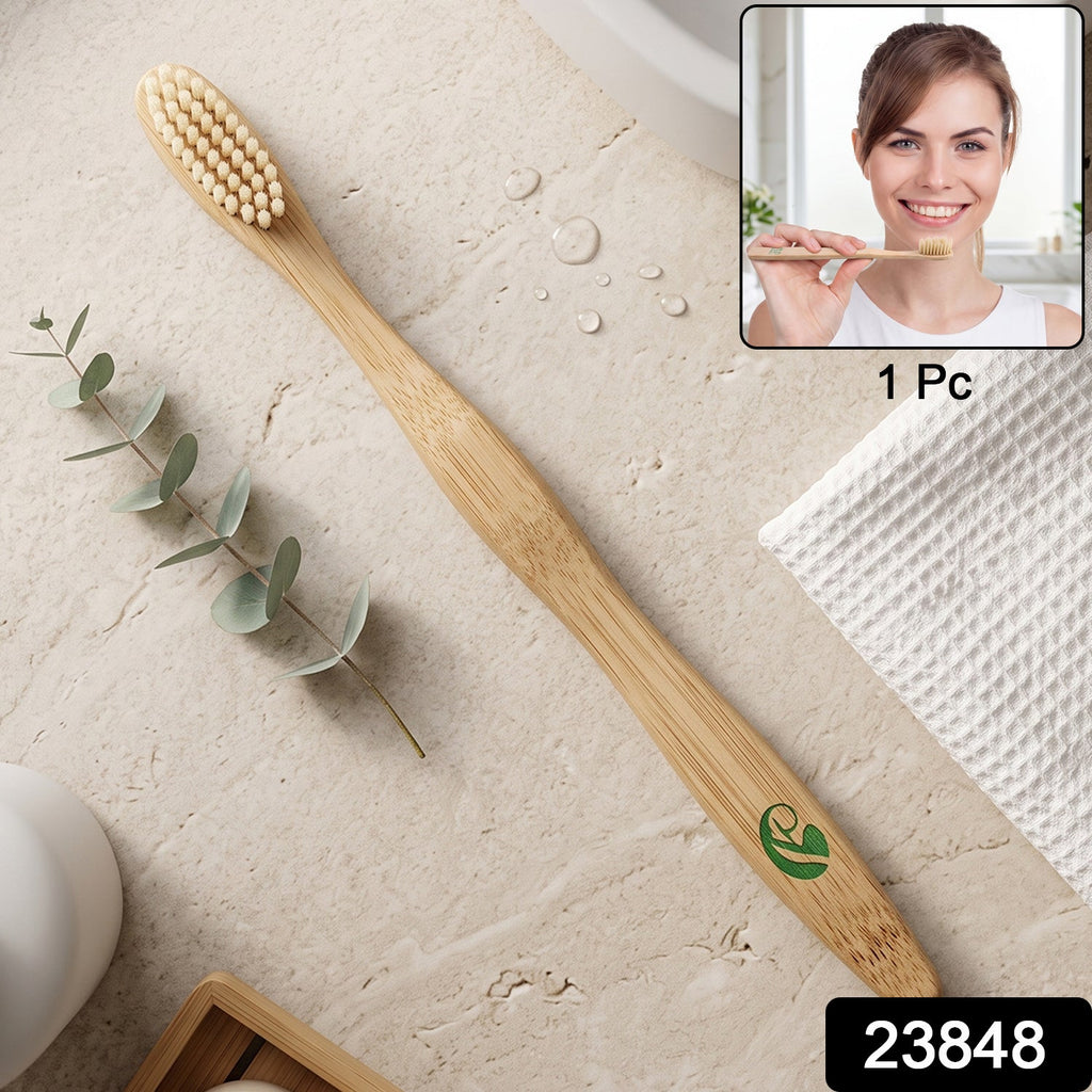 Natural bamboo toothbrush with soft bristle head and green leaf emblem on handle
